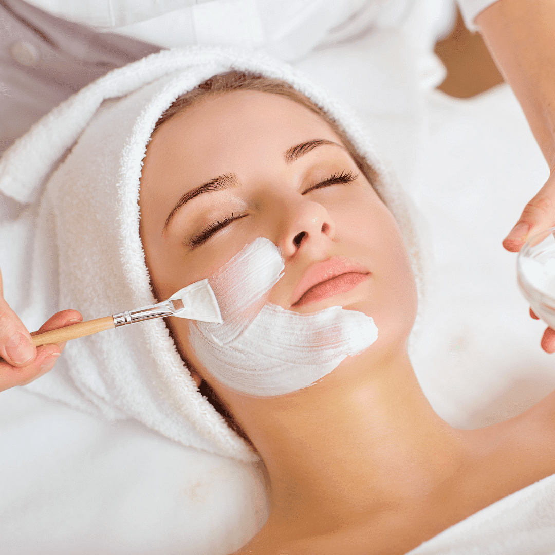 Woman receiving a facial mask treatment at a spa.