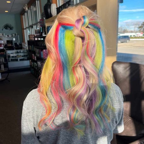 Rainbow Peekaboo Hair Color with Half Up Style in Comstock Park Salon